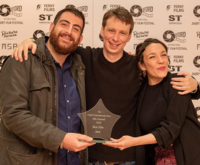 Fabio Patrassi and Elisabetta Rosa celebrate winning Best Film with Festival Director Andy Carslaw